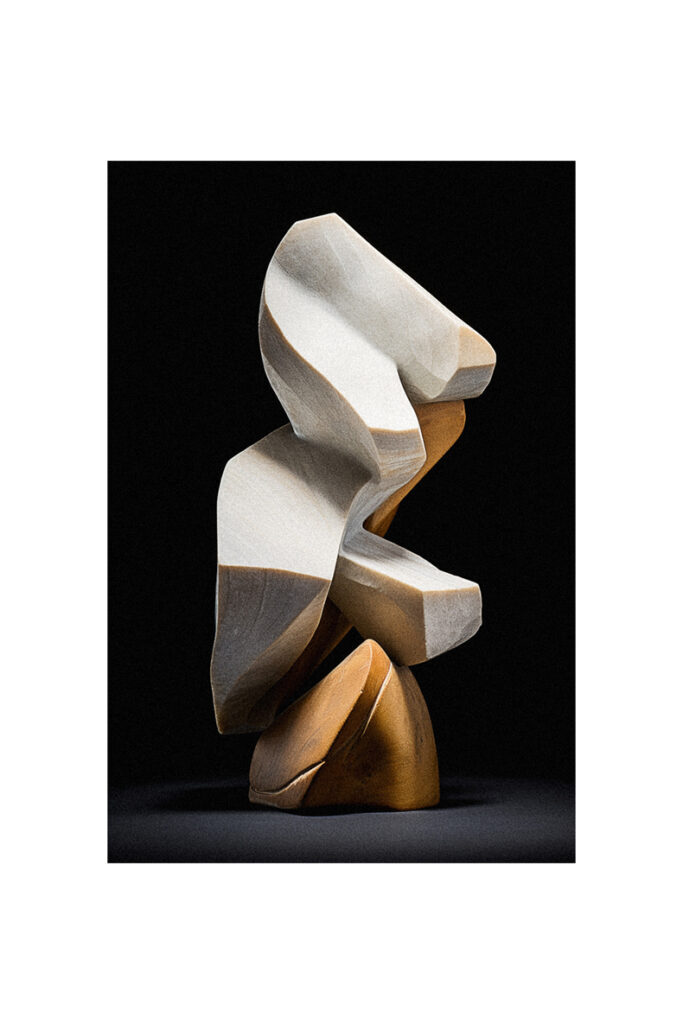 A white and brown sculpture on a black background.