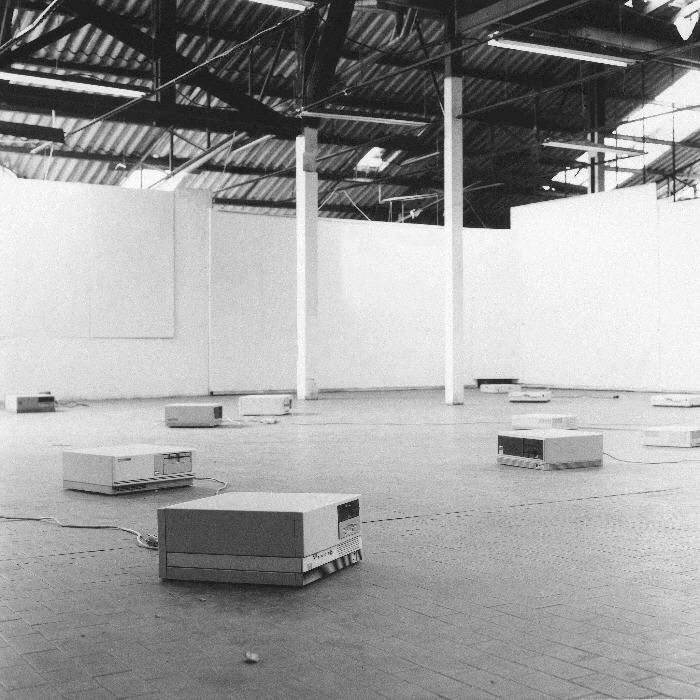 A black and white photo of a room full of boxes.