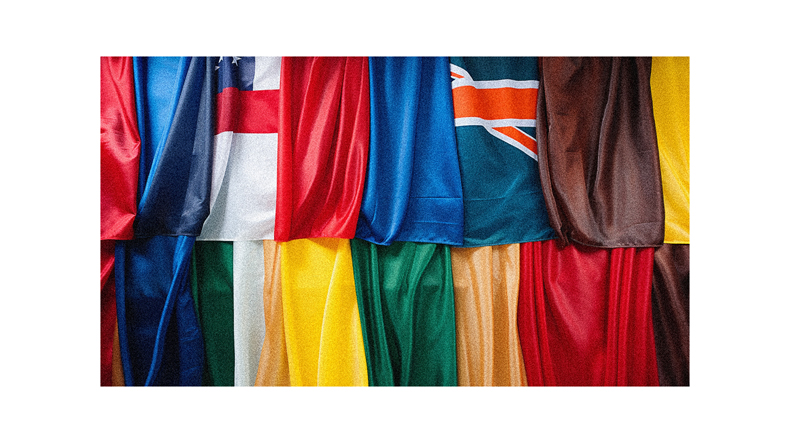 A group of flags hanging on a wall.