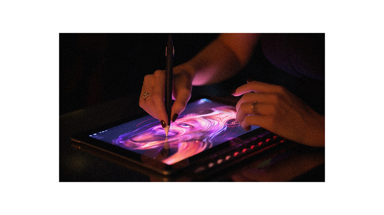 A person is using a tablet to draw on it.
