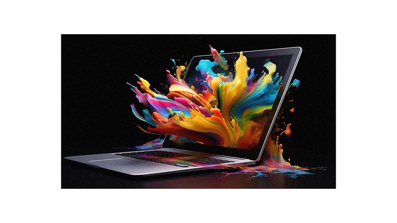 A laptop with colorful paint splashing out of it.