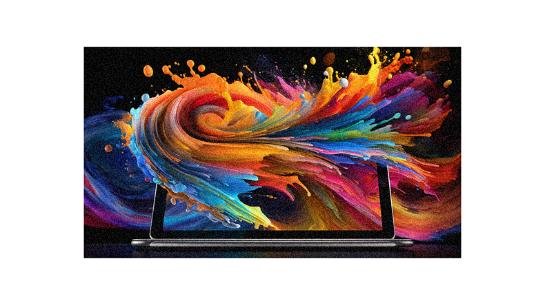 A laptop with colorful paint splashing out of it.