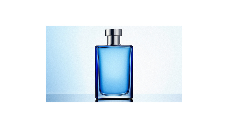 A bottle of blue perfume on a blue background.