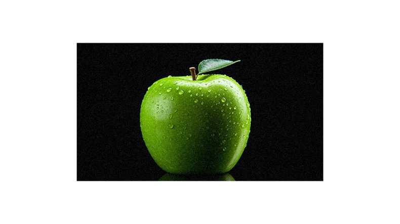 A green apple on a black background.