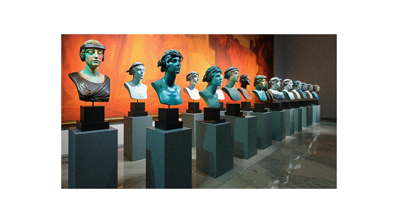 A group of busts are displayed in a museum.