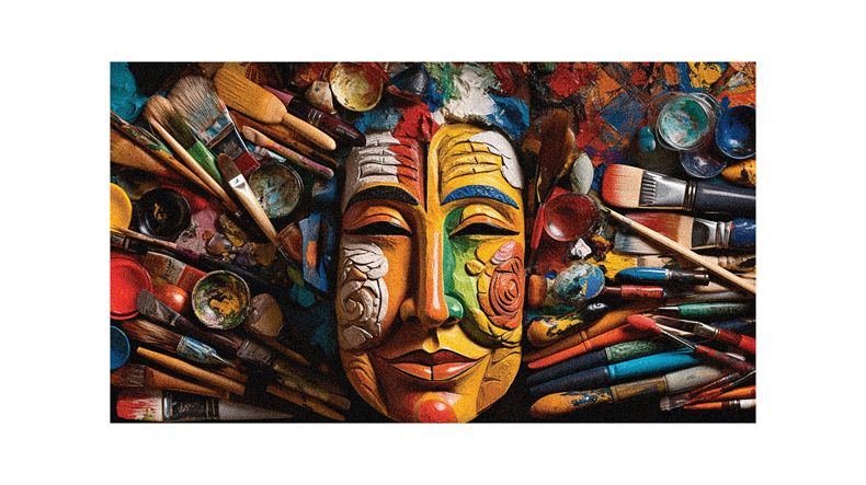 A painting of a buddha mask surrounded by paint brushes.