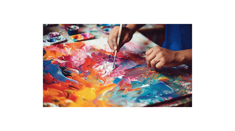 A person is painting with a paintbrush on a canvas.