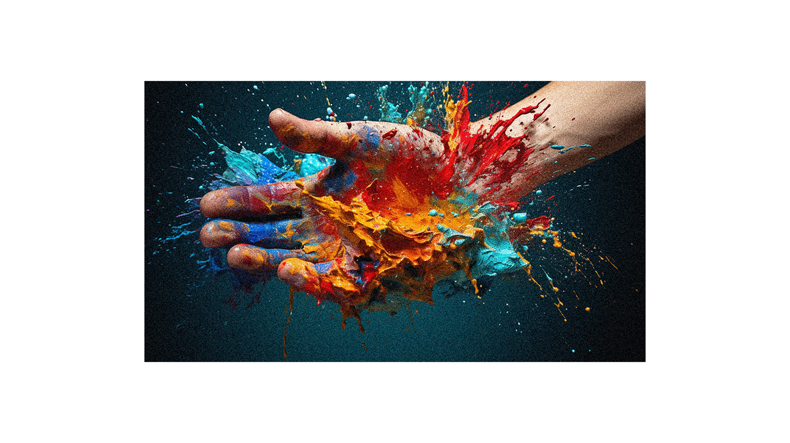 A hand with paint splatters on it.