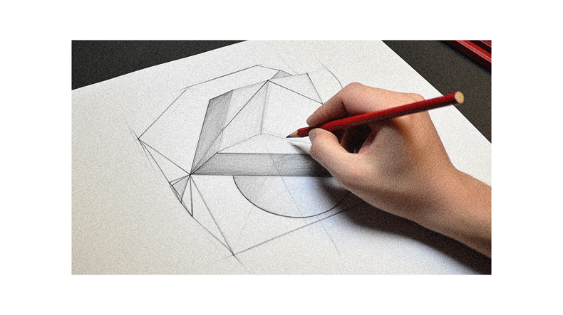 A person is drawing a geometric shape on a piece of paper.