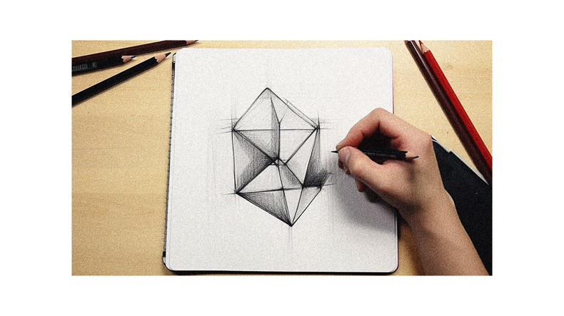 A person drawing a geometric shape on a piece of paper.