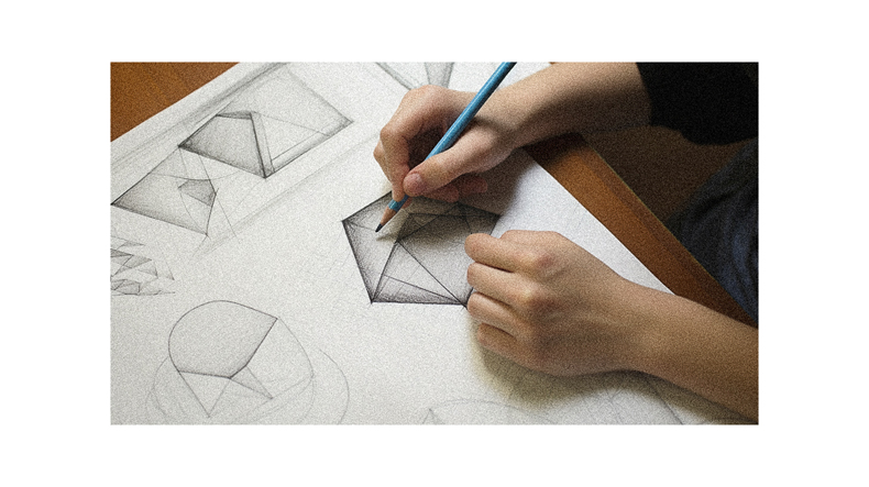 A person drawing on paper with a pencil.