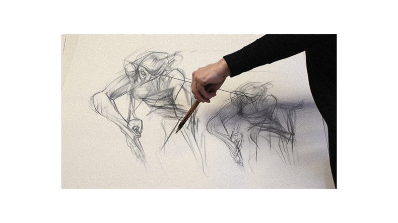 A person is holding a pencil and drawing a figure.