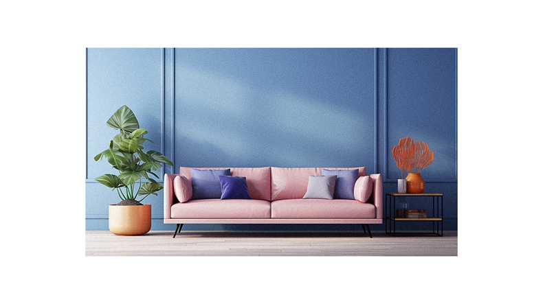A pink couch in front of a blue wall.