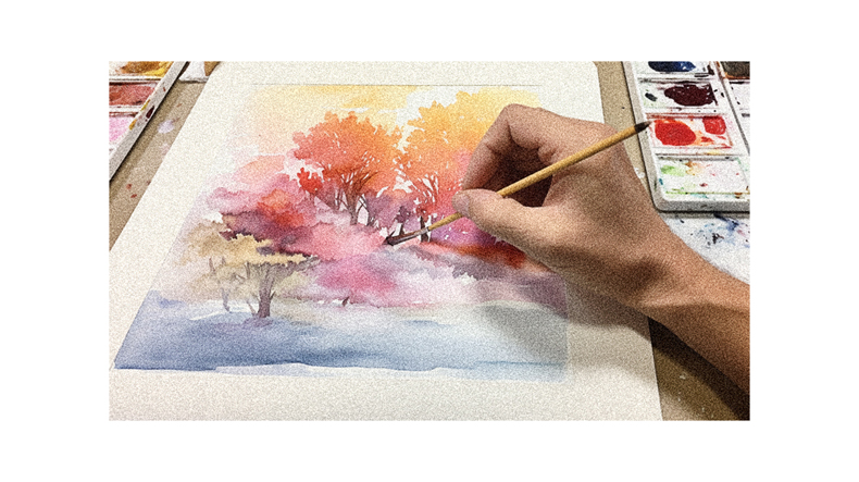 A person is painting a watercolor painting with a brush.